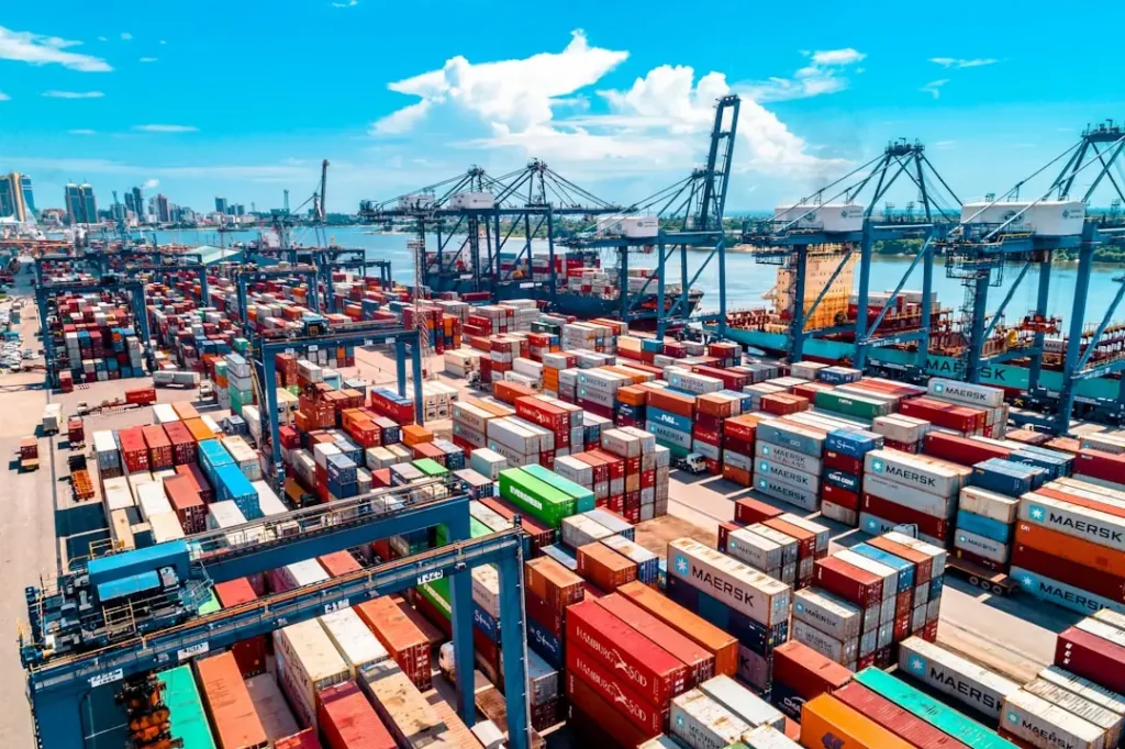 Aerial view of a container port with stacked shipping containers